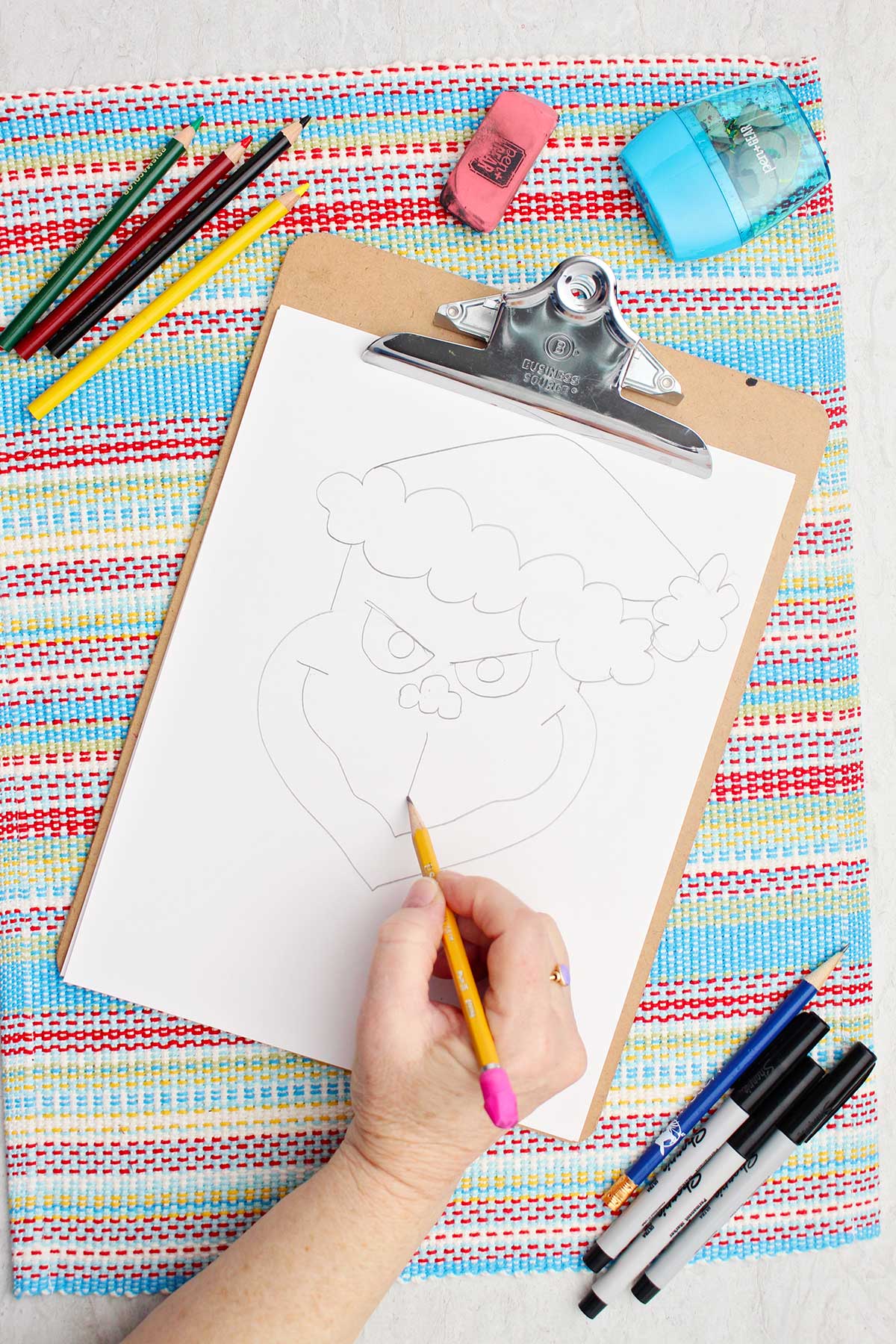 Individual working on some facial features of their Grinch illustration.