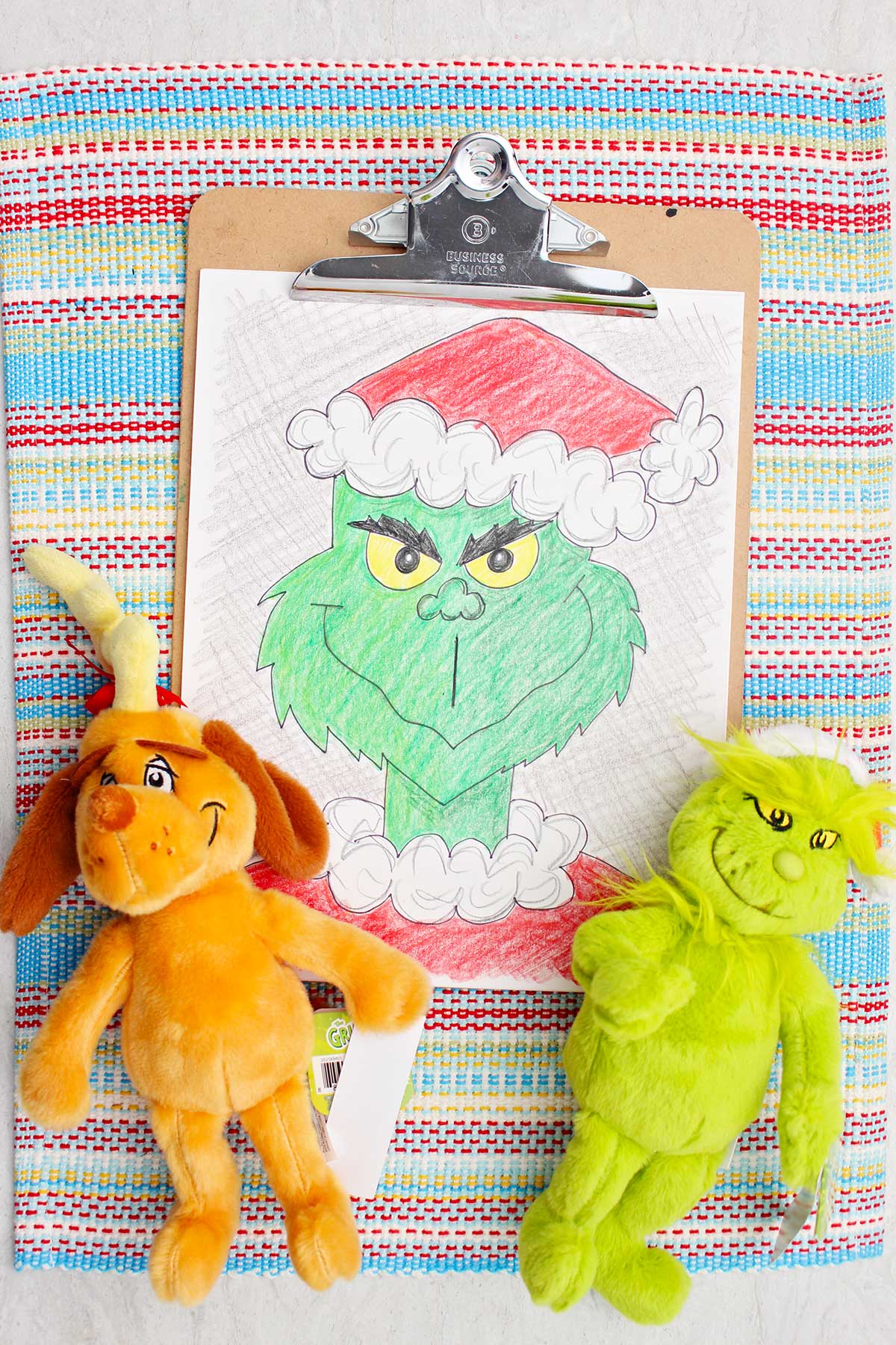 Colored version of a Grinch sketch accompanied by Grinch and Max plush toys.
