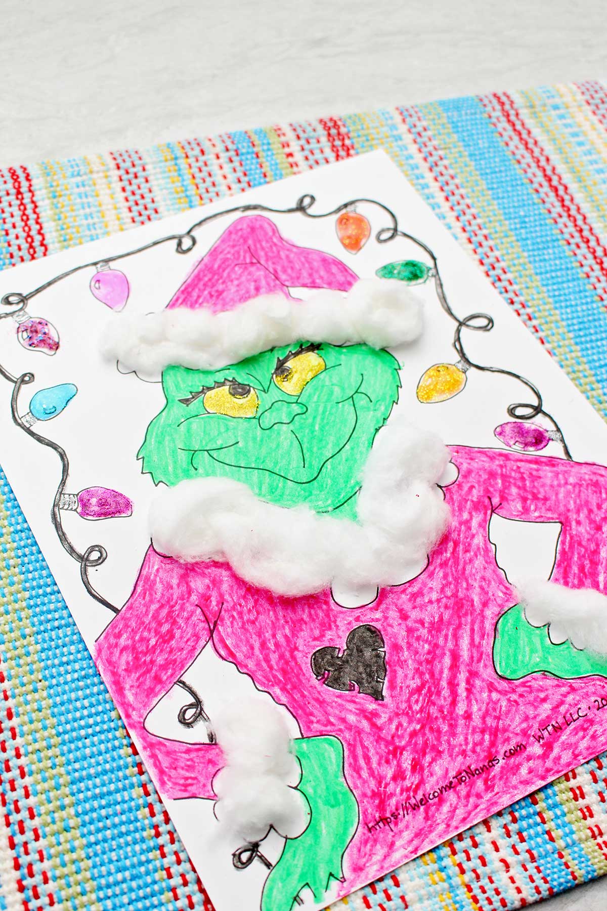 Close-up of a finished Grinch coloring page.