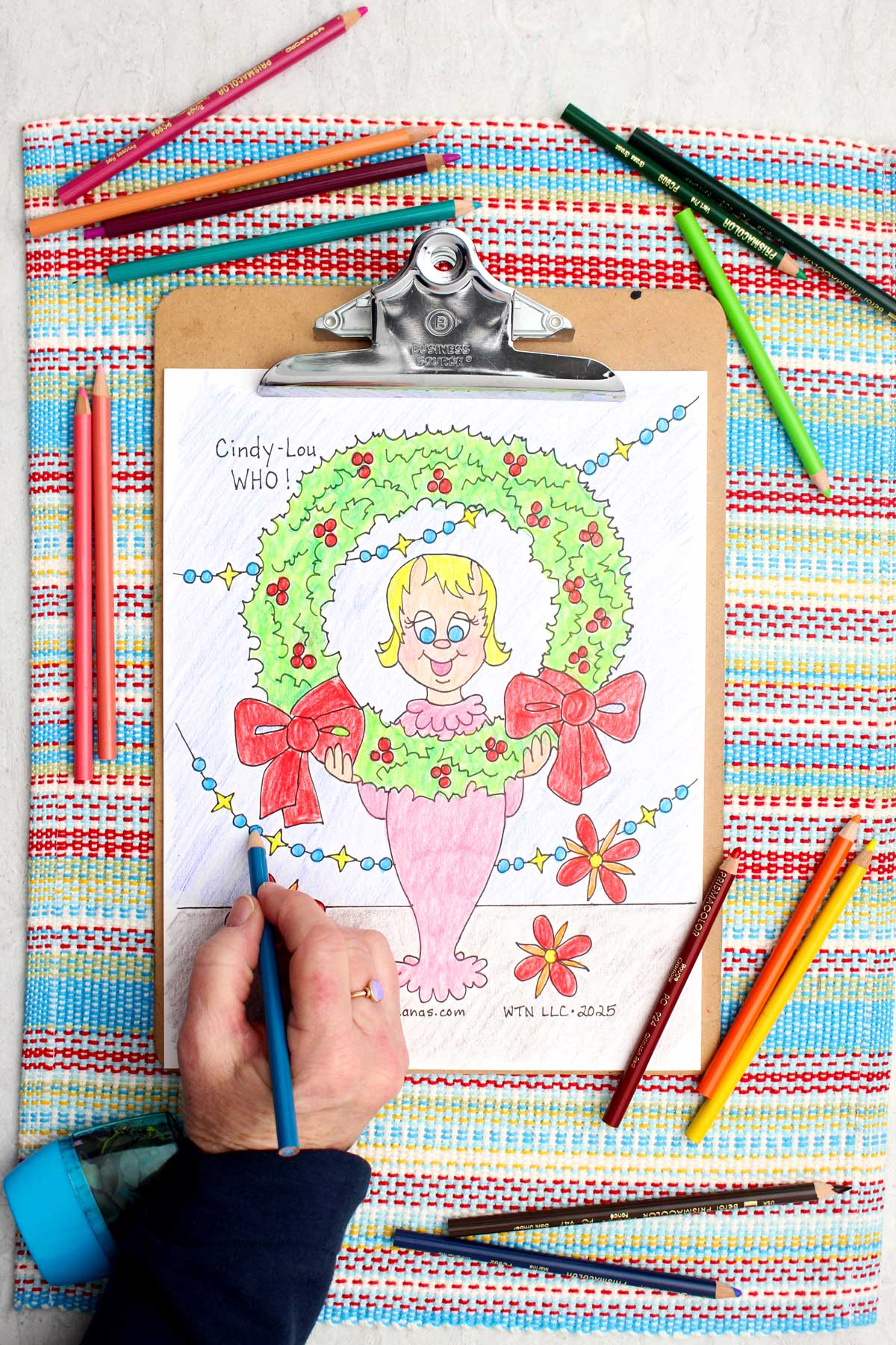 A coloring page depicting Cindy Lou Who and a Christmas wreath from How the Grinch Stole Christmas