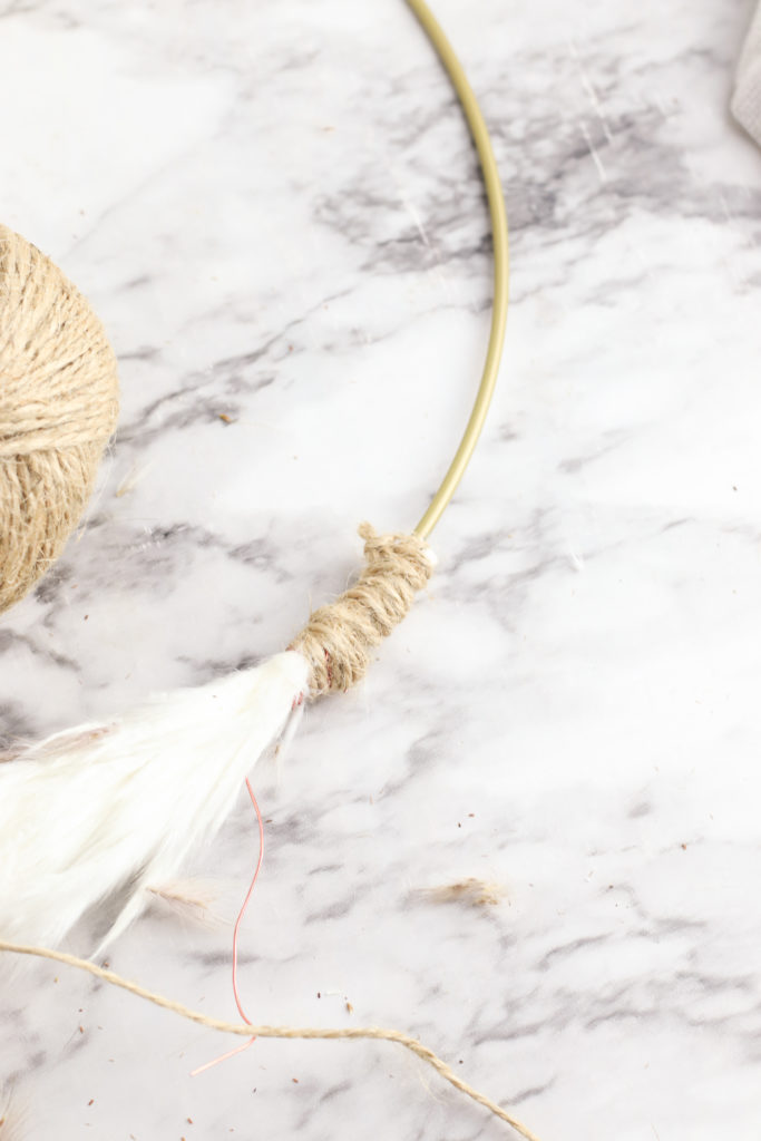 Wrapping twine around the end of the pampas grass.