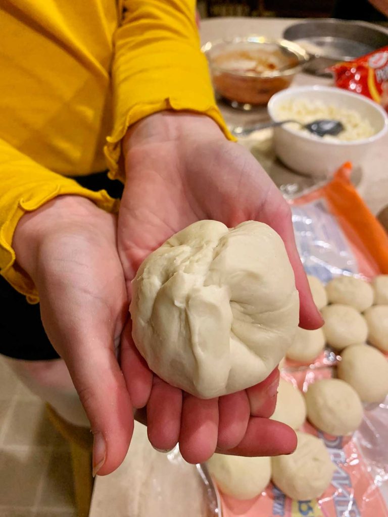 A child grasping a ball of dough.