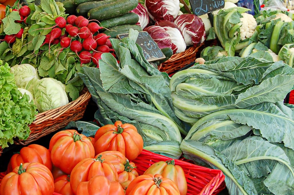 Fresh produce arranged in a farmers market display.