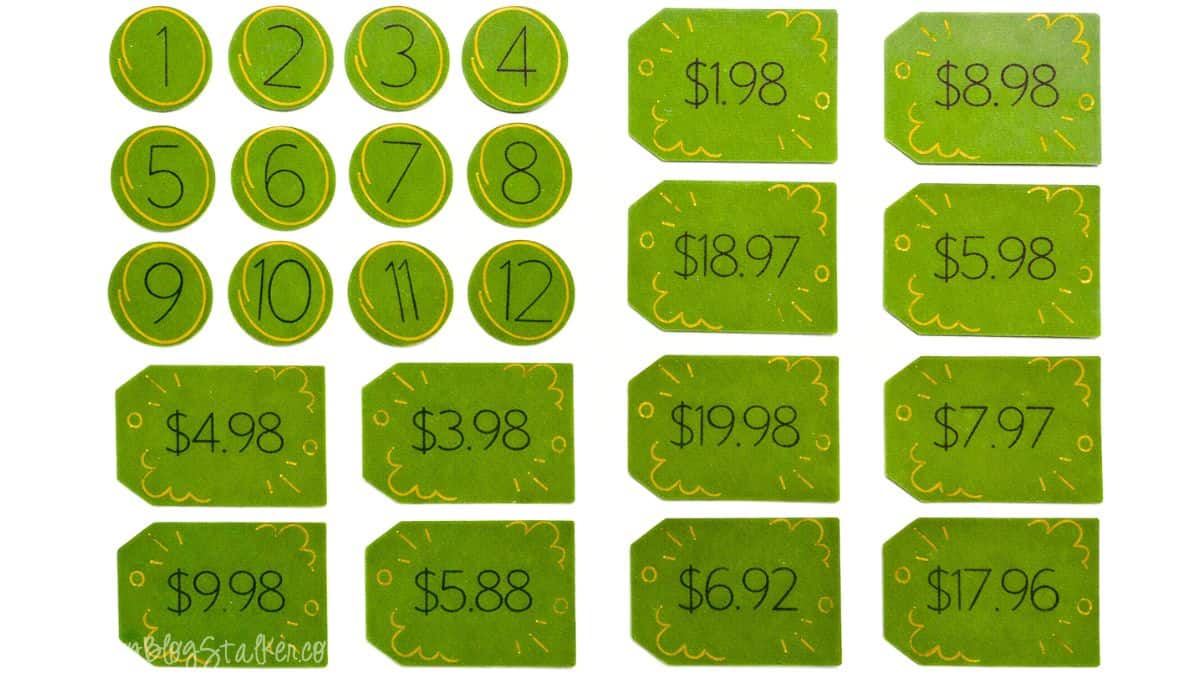 Numbered circles and price tag cards featuring dollar amounts utilized as pieces for a DIY Price Is Right style baby shower guessing game.