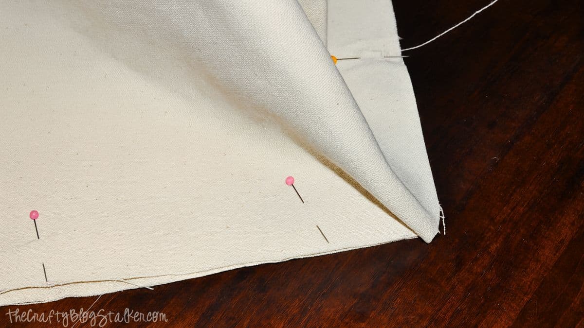 Step 5 A Canvas tote bag fabric pieces pinned together along the bottom edge before sewing the seam.