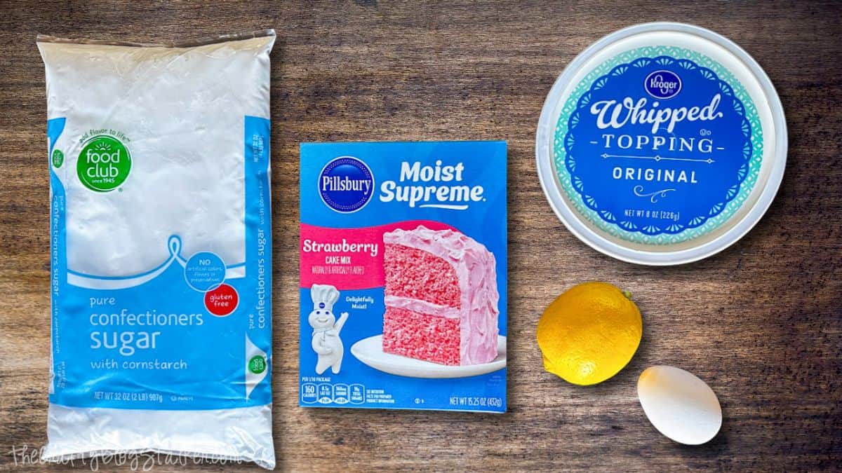 Pink Lemonade Cookie Ingredients Pink lemonade crinkle cookies elegantly arranged on a baking sheet, dusted with powdered sugar and baked until cracked.