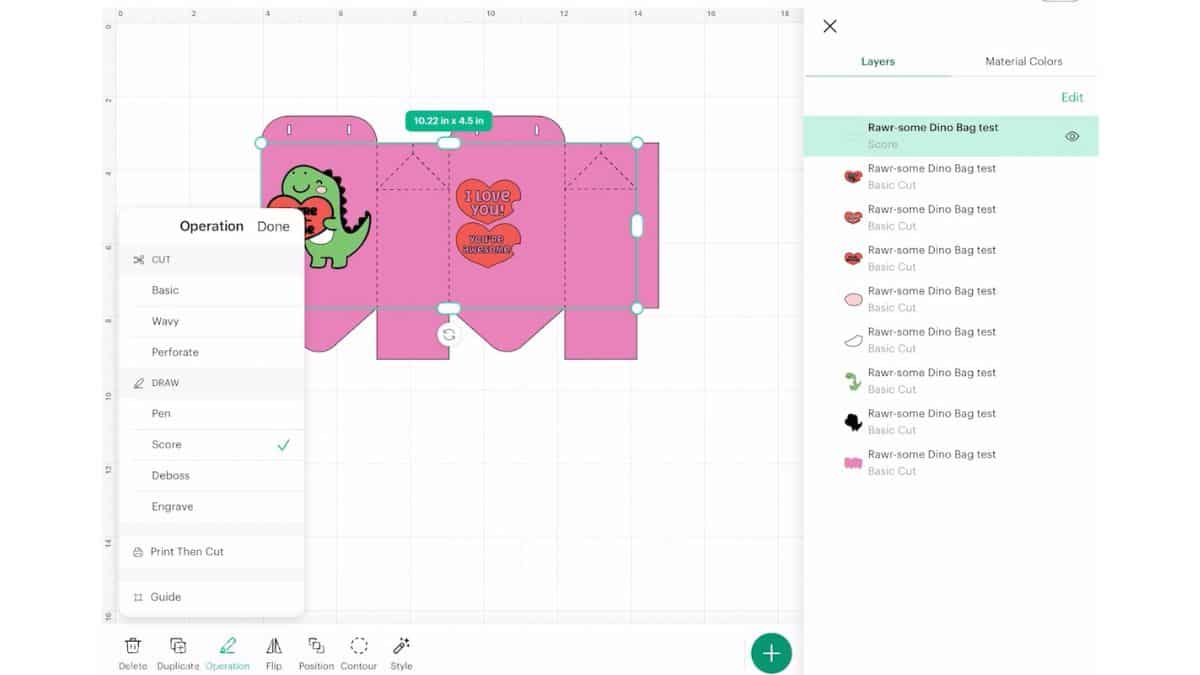 Cricut Design Space screen illustrating a dinosaur Valentine treat bag with fold lines indicated and set to score, along with the layers panel opened.