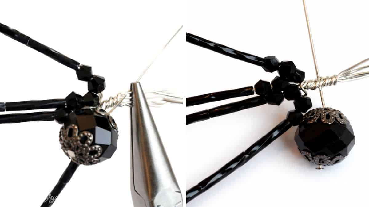 Close-up of pliers twisting wire around a beaded spider body to secure the head pin while attaching the legs.