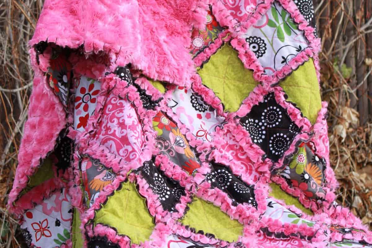 Minky rag quilt shown on a chair.