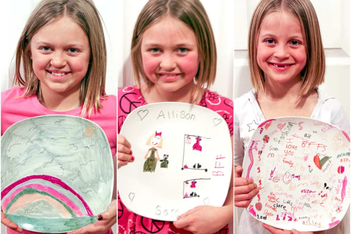 Three children presenting their baked sharpie plates.