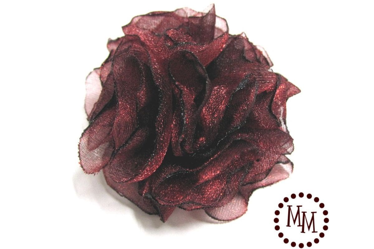 Crafted singed organza pom pom flower featuring layered, heat-treated fabric petals, displayed as a completed fabric flower embellishment on a white backdrop.