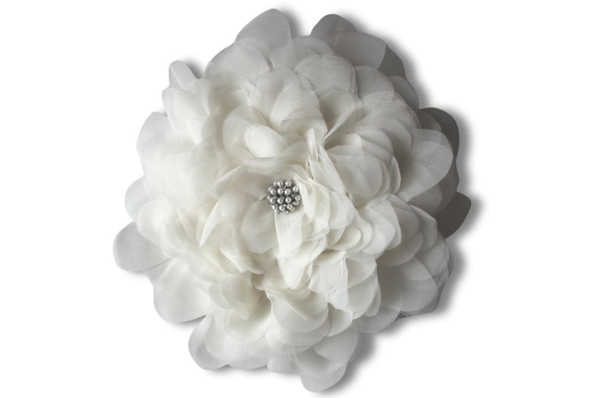Large artisan fabric flower with layered petals and a pearl center detail, captured against a white backdrop as a decorative craft bloom.
