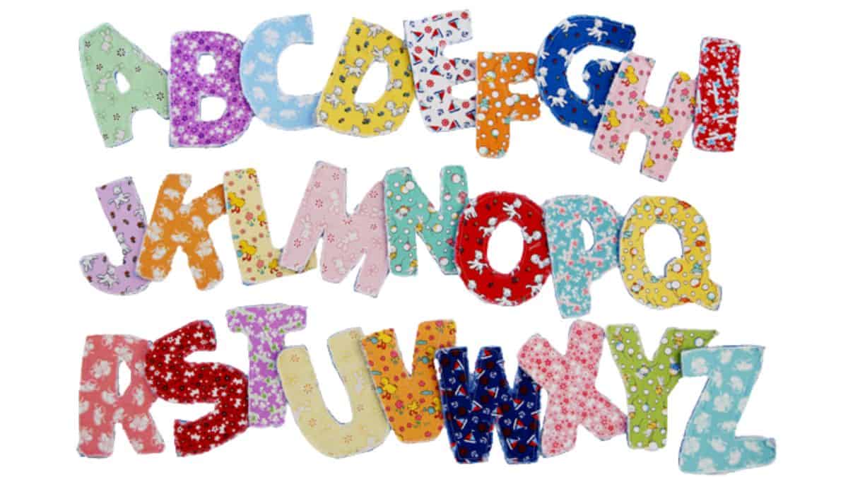 Sewn fabric alphabet letters A to Z, crafted from patterned cotton fabric, arranged on a white background.