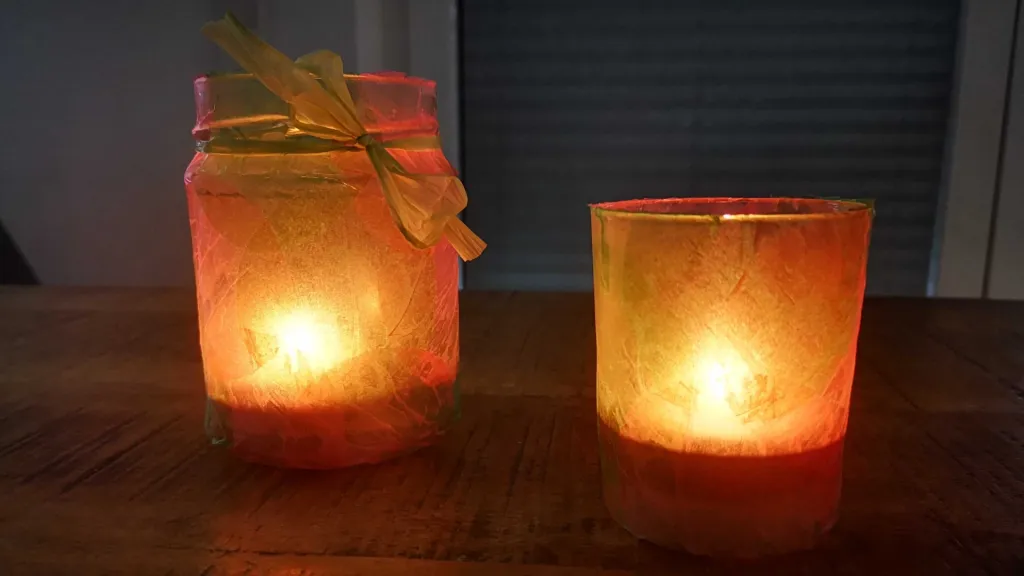two lanterns made from old jam jars