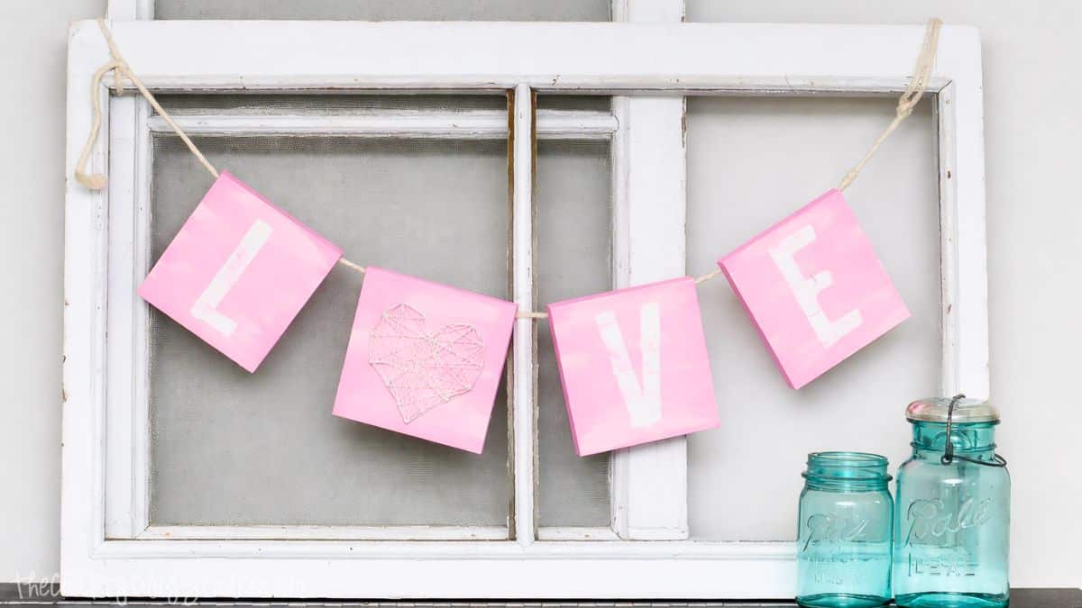 Adore this Valentines Day Mantel! Obtain the tutorial for that charming Love Sign too! Artisan Valentine's Day banner displaying LOVE, suspended across a vintage window frame with decorative mason jars on a shelf.