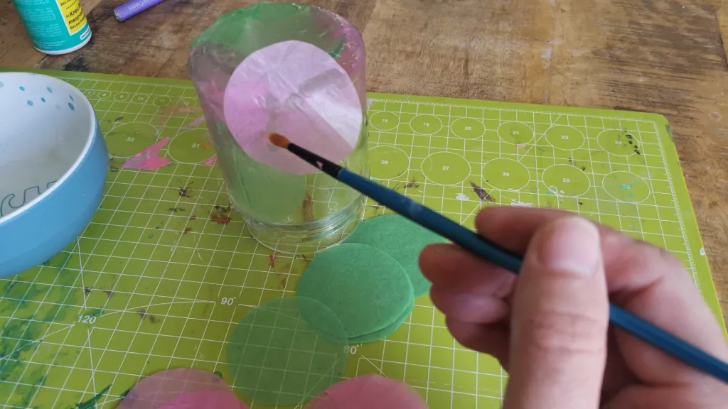 Circles of tracing paper are glued to the glass